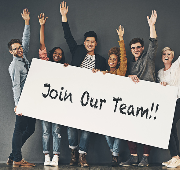 Group of co-workers holding a join our team sign.